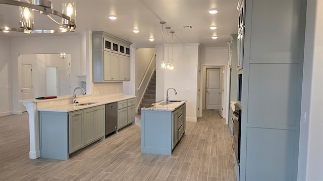 kitchen with tasteful backsplash, dishwasher, an island with sink, a peninsula, and a sink