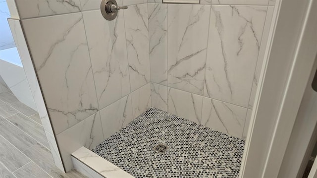 bathroom with tiled shower