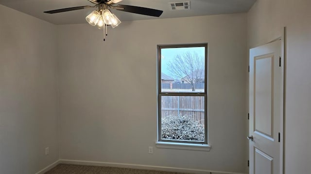 empty room with ceiling fan, carpet, visible vents, and baseboards