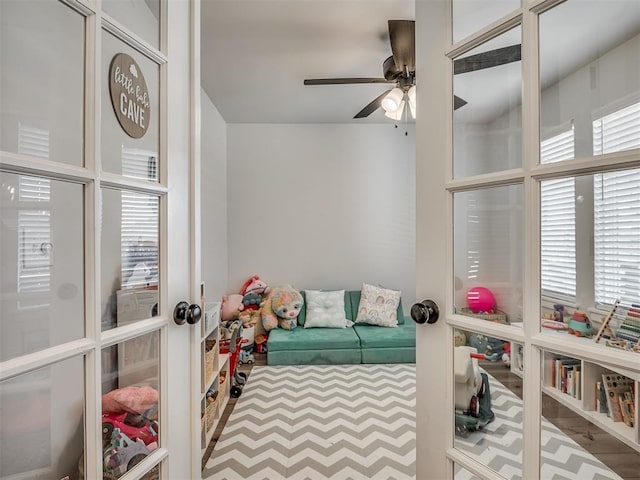 game room with a ceiling fan