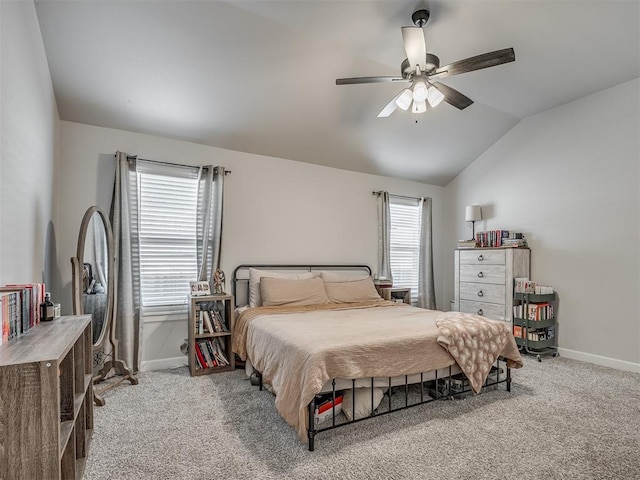 carpeted bedroom with lofted ceiling, a ceiling fan, and baseboards