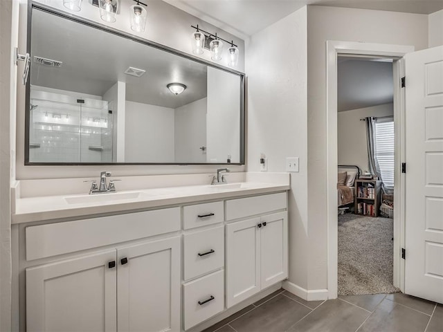 bathroom featuring double vanity, a sink, visible vents, and a shower stall