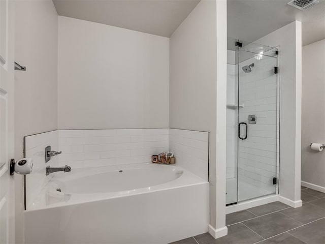 bathroom with a stall shower, visible vents, baseboards, a garden tub, and tile patterned flooring