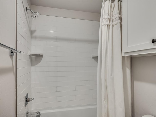 bathroom with shower / bath combo with shower curtain