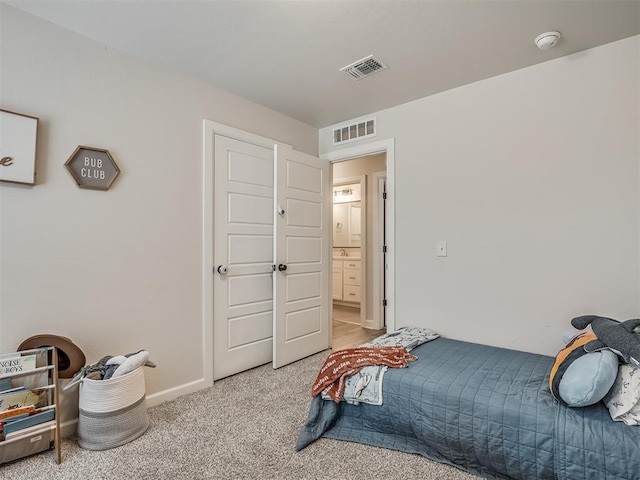 bedroom featuring light carpet, visible vents, and baseboards