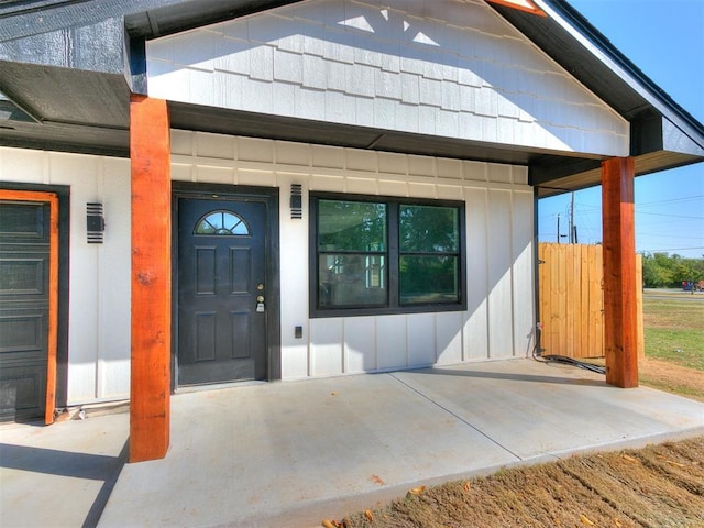 view of exterior entry with board and batten siding