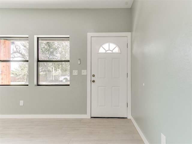 entryway featuring baseboards