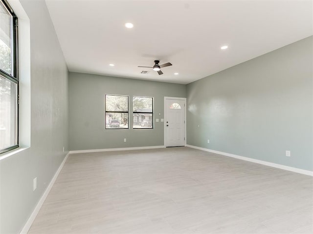 spare room featuring visible vents, recessed lighting, a ceiling fan, and baseboards