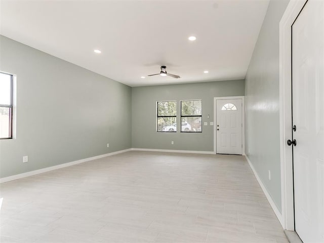 empty room featuring recessed lighting, ceiling fan, and baseboards