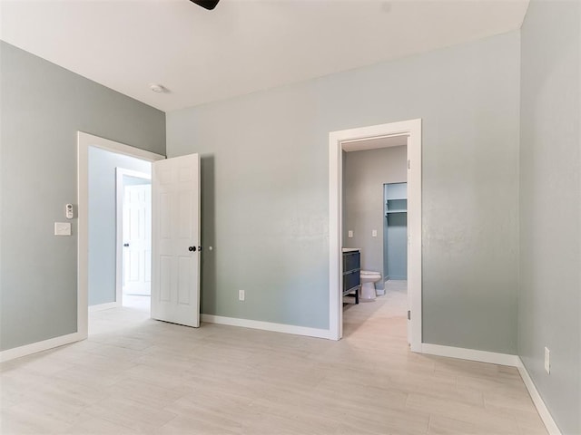 unfurnished bedroom with light wood-type flooring and baseboards