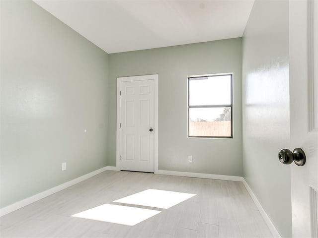 spare room featuring baseboards