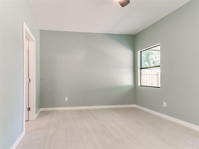 unfurnished room featuring light wood finished floors and baseboards