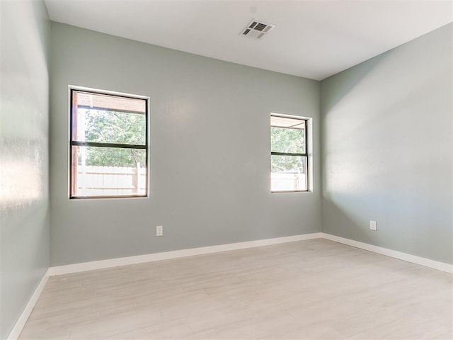 spare room with visible vents and baseboards