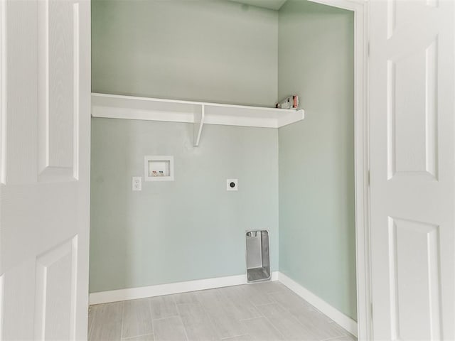 laundry area featuring laundry area, hookup for a washing machine, electric dryer hookup, and baseboards