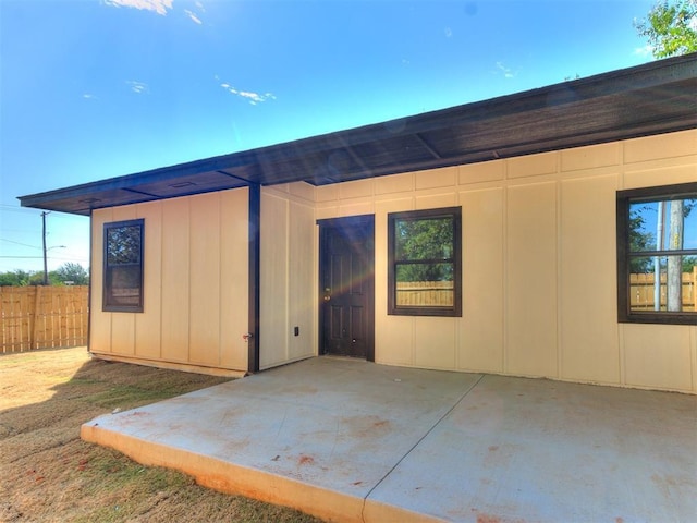 back of house featuring a patio area and fence