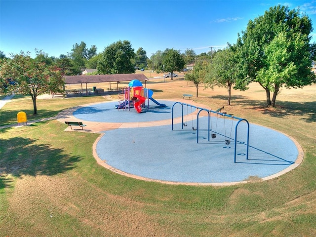 view of home's community featuring playground community and a lawn