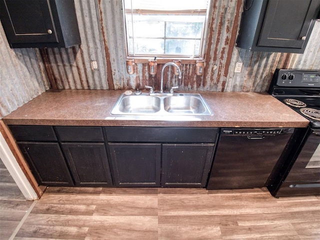 kitchen with light wood-type flooring, black appliances, and a sink