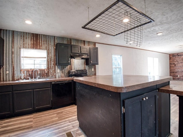 kitchen with under cabinet range hood, a textured ceiling, light wood-type flooring, black appliances, and a sink