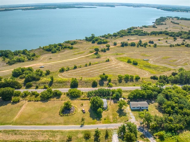 birds eye view of property featuring a water view and a rural view