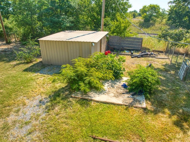 view of yard with an outbuilding, fence, and a shed