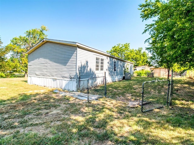 view of side of property featuring a yard and fence