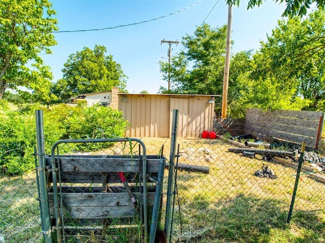 view of yard with a vegetable garden, a gate, and fence