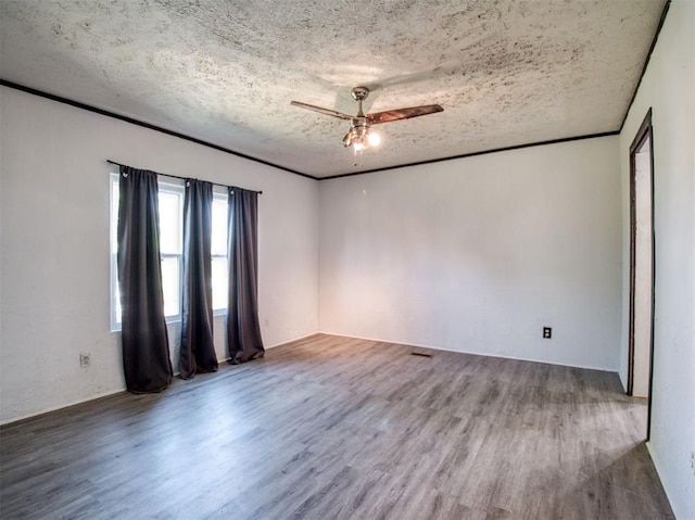 unfurnished room with ornamental molding, ceiling fan, a textured ceiling, and wood finished floors