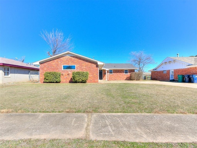 ranch-style home with a front lawn and brick siding