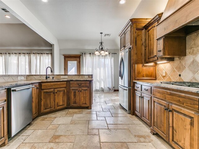 kitchen with custom exhaust hood, stone tile floors, stainless steel appliances, recessed lighting, and a sink