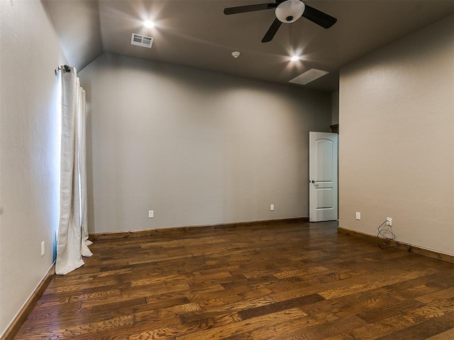 spare room with a ceiling fan, dark wood-style flooring, and visible vents