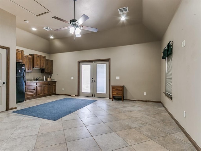 kitchen with baseboards, visible vents, freestanding refrigerator, french doors, and light tile patterned flooring