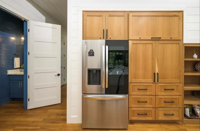 kitchen featuring brown cabinets, light wood-style flooring, and stainless steel refrigerator with ice dispenser