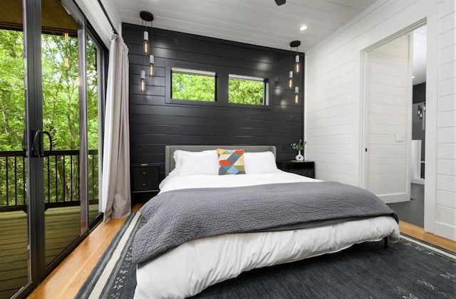 bedroom with recessed lighting and wood finished floors