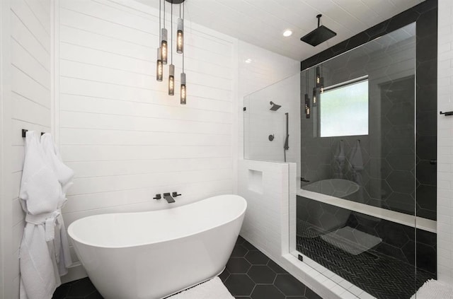 bathroom featuring a freestanding tub, recessed lighting, a tile shower, and tile patterned floors