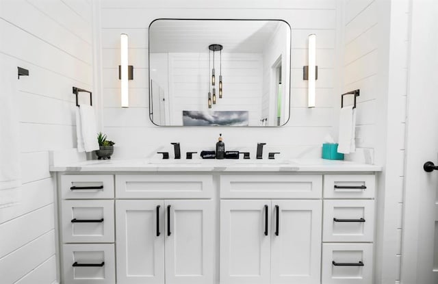 full bathroom featuring a sink and double vanity