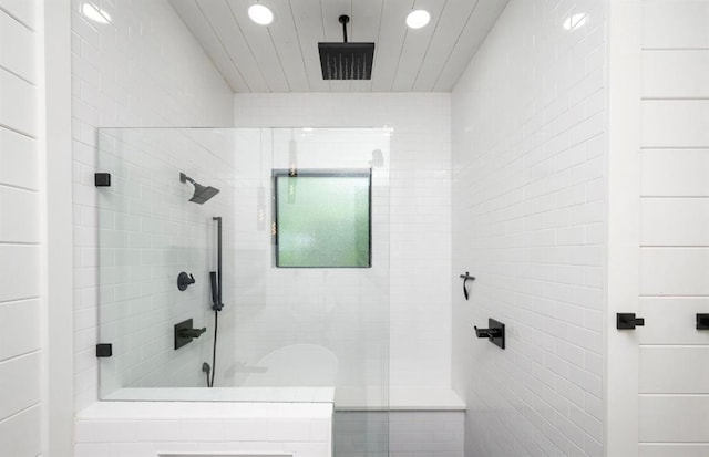 bathroom featuring a tile shower and recessed lighting