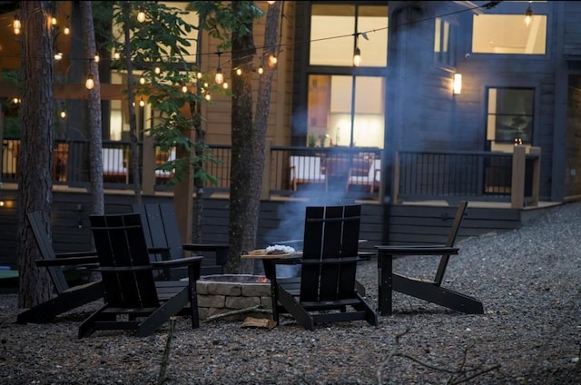 exterior space featuring an outdoor fire pit and a wooden deck