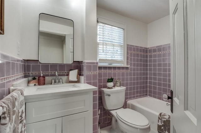 bathroom featuring tile walls, vanity, and toilet