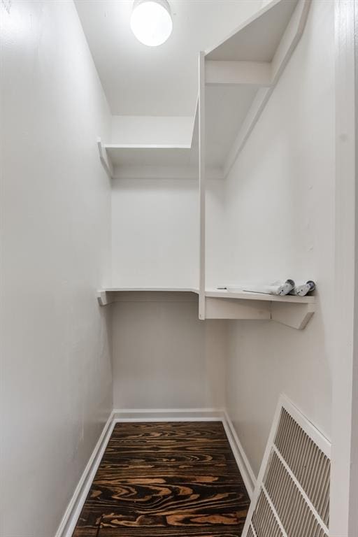 walk in closet with visible vents and wood finished floors