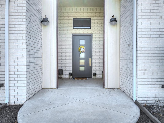 property entrance with brick siding