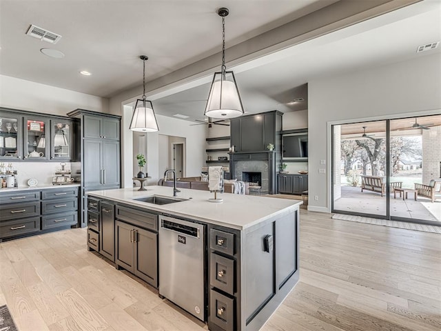 kitchen with visible vents, a sink, light wood finished floors, and stainless steel dishwasher