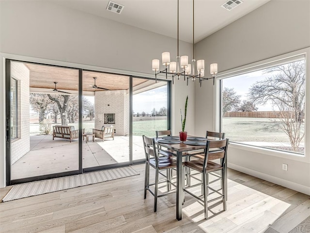 dining area featuring light wood-style flooring, visible vents, and a healthy amount of sunlight