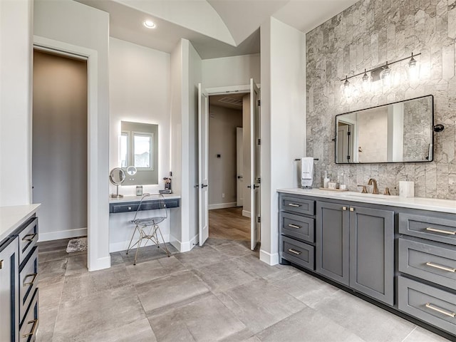 full bathroom with recessed lighting, vanity, and baseboards