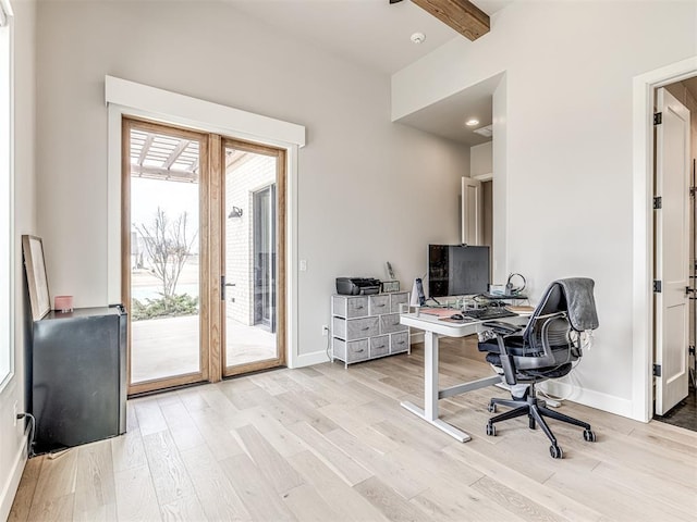 home office with light wood-type flooring, beam ceiling, and baseboards