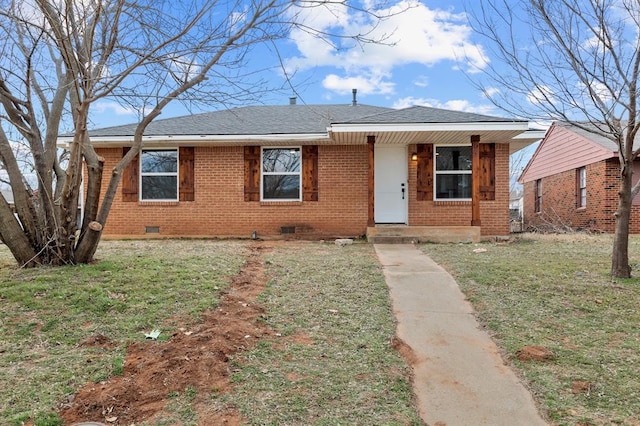 view of front of home with a front yard, crawl space, brick siding, and roof with shingles