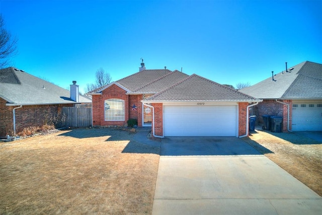 ranch-style home featuring driveway, an attached garage, fence, a front lawn, and brick siding