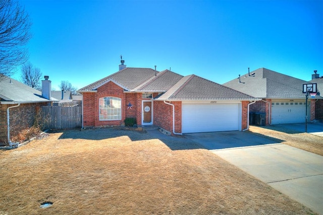 single story home with a garage, brick siding, a shingled roof, fence, and driveway