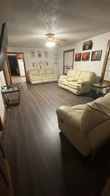 living room with dark wood-style floors, a textured ceiling, and a ceiling fan