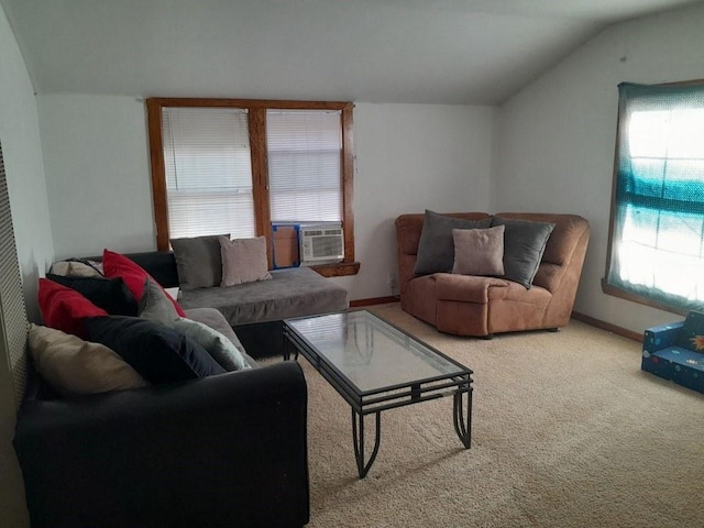 carpeted living area with lofted ceiling, cooling unit, and baseboards