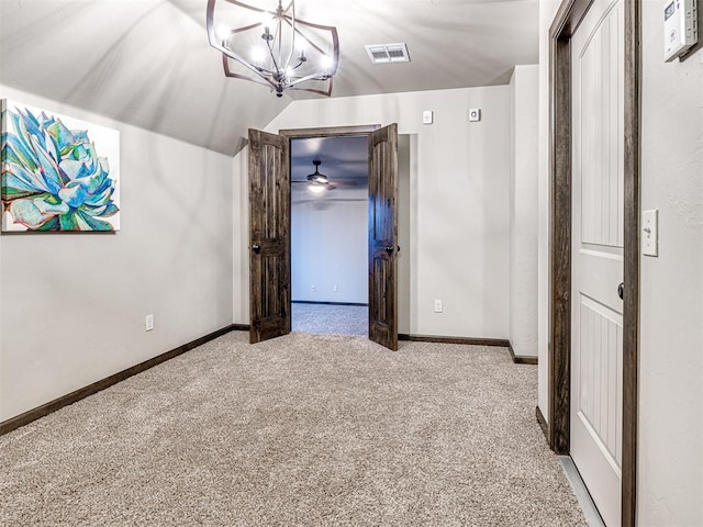 interior space featuring vaulted ceiling, visible vents, and baseboards